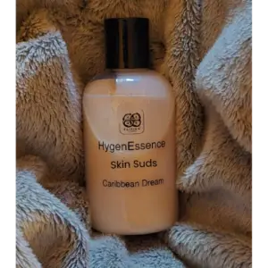 Elixian Essence body wash bottle lying flat, showcasing the product label and branding