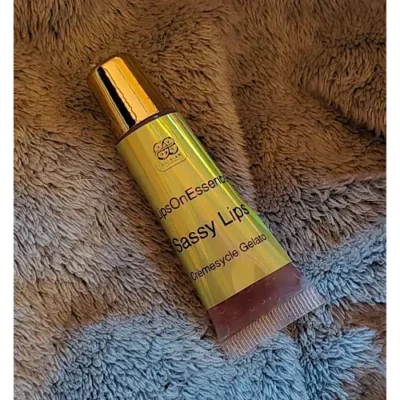 Elixian Essence lip gloss in a convenient squeeze tube with the lid on, ready for easy use