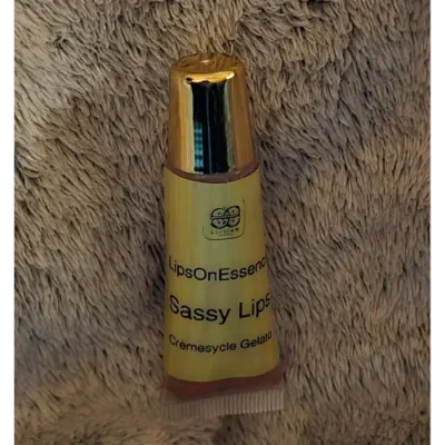 Elixian Essence lip gloss in a convenient squeeze tube sitting upright with the lid on, ready for easy use