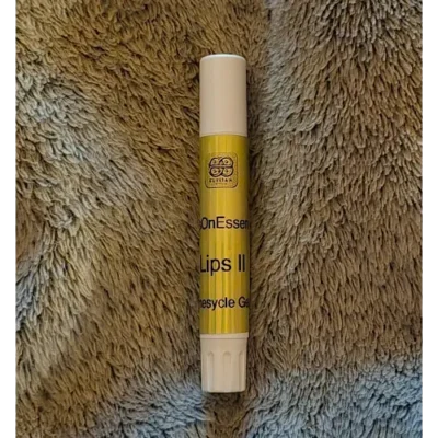 Elixian Essence Lips II lip balm in a crisp white tube, designed for easy application