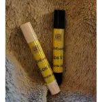Elixian Essence Lips II pocket-sized lip balm in black and white tubes, side by side for comparison